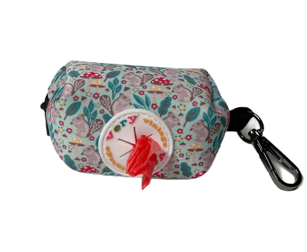 Green dog poop bag dispenser with adorable gray squirrel and mushroom pattern.