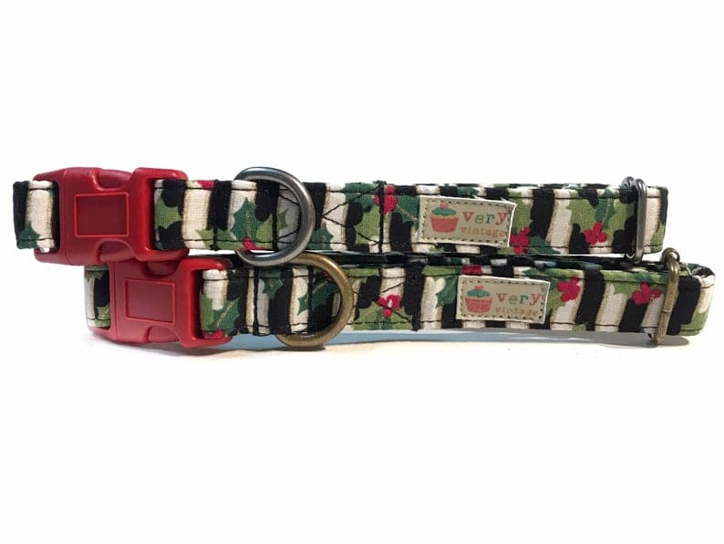 A close-up of the black and white striped collar with red holly, showcasing the festive, holiday-ready design. Available with antique brass or antique silver hardware, this collar adds a seasonal touch to your pet’s look. Cat collars with breakaway buckles for safety. LA made.