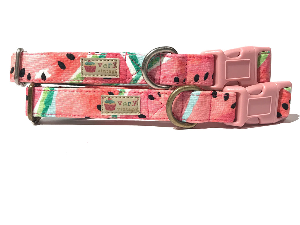 A light pink dog collar with a fun, light green watermelon pattern, made from organic cotton with antique brass or silver hardware. Handmade in Los Angeles.